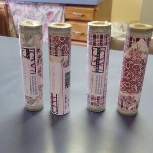 Vintage Wallpaper Rolls with Floral and Plaid Patterns
